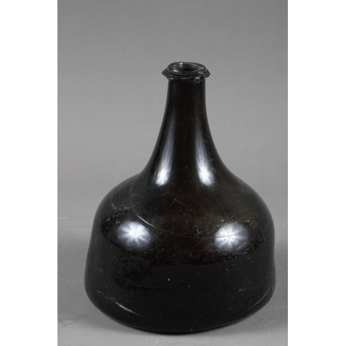 38 - An early 18th century green glass onion wine bottle, 7 1/4