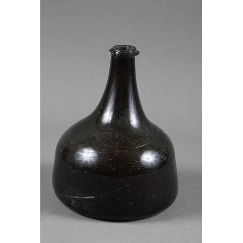 38 - An early 18th century green glass onion wine bottle, 7 1/4