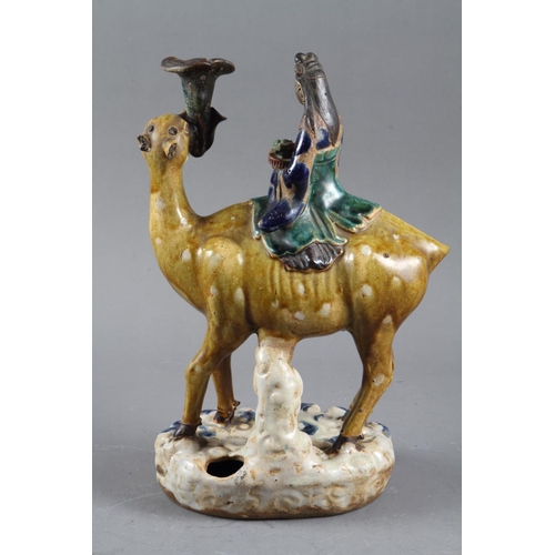 92 - A Chinese porcelain incense stand, modelled as Kuan Yin on a camel, on rockwork base, 12 1/4