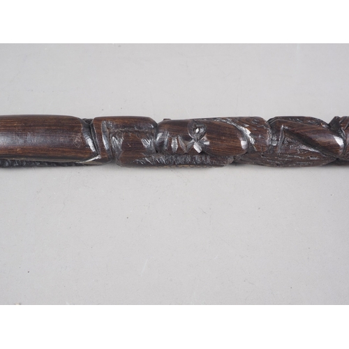 127 - An African carved ebony stick, 38 1/2