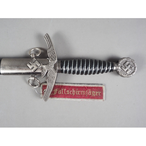 161 - A Luftwaffe officer's reproduction sword and scabbard, and a reproduction Goring Panzer dagger and s... 