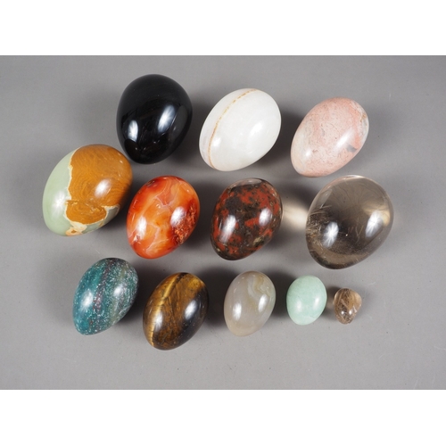 225 - A collection of turned hardstone eggs, various sizes, including jade, agate, Jasper, etc