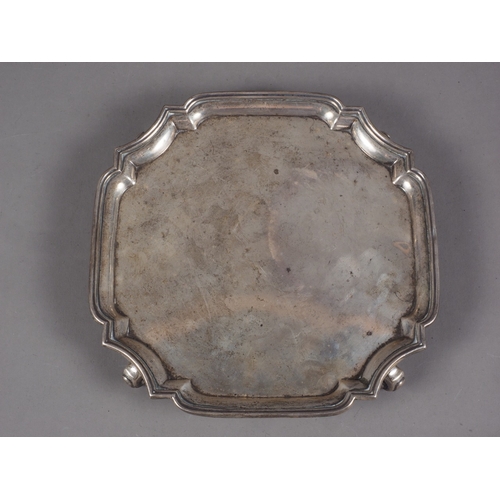 264 - A silver card tray, raised on four scrolled supports, 11oz troy approx