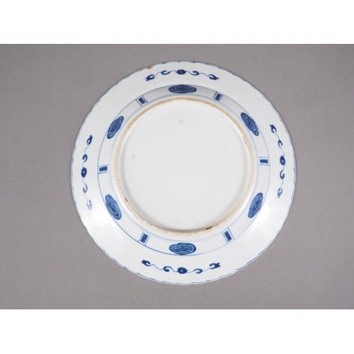 90 - A Chinese blue and white plate with figures in a landscape decoration and panelled borders Cracked a... 