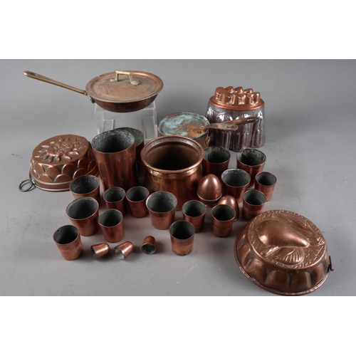 112 - A quantity of copper measures, jelly moulds and other items