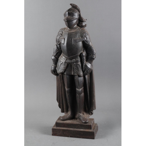 116 - A cast iron door stop, formed as a knight, on rectangular stepped base, 20 3/4” high