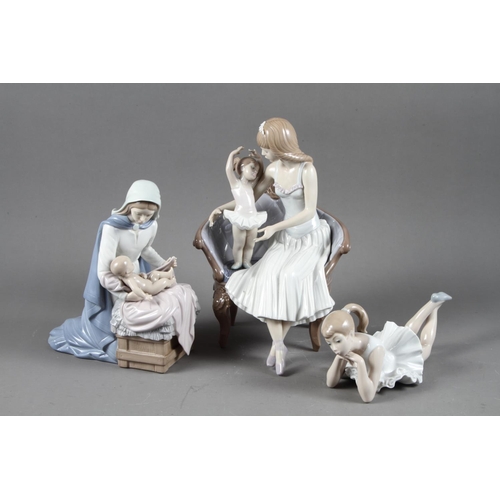 12 - A Lladro figure of a woman and child on a sofa, 10” wide, and two Nao figures