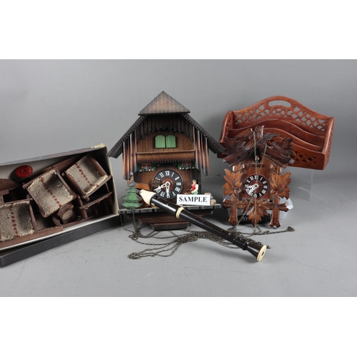 137 - Two cuckoo clocks, a carved hardwood model bird, 10” long, wooden dolls house furniture, three woode... 