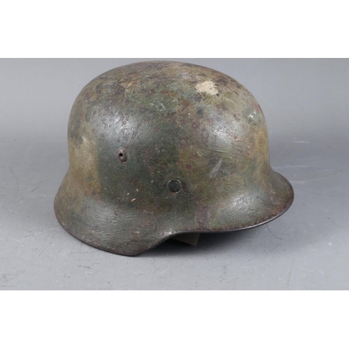 143 - A WWII German helmet with leather lining