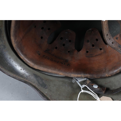 143 - A WWII German helmet with leather lining