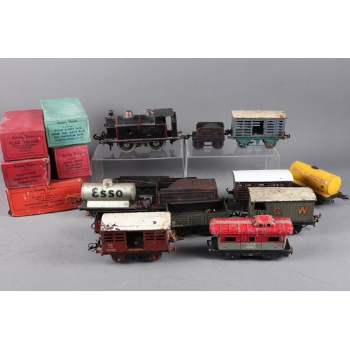 167 - A quantity of mostly tin-plate 0 Gauge train items including a locomotive, carriages and other acces... 