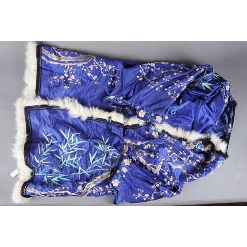 173 - An Oriental embroidered silk jacket with floral design on a blue ground and coney fur edging (for re... 