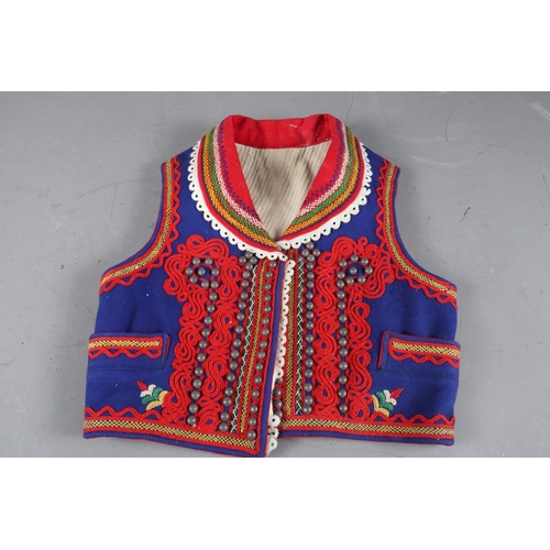 174 - A girl’s Polish embroidered waistcoat, back 14” long