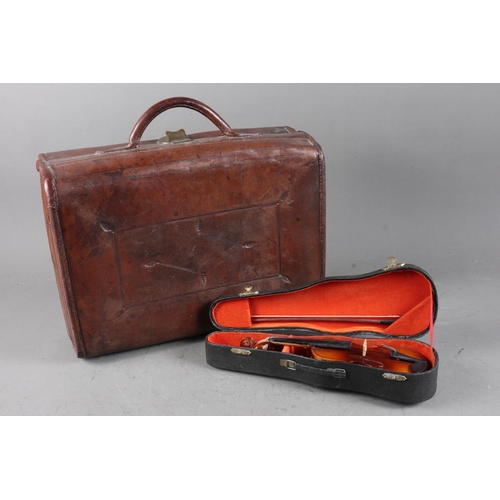 209 - An antique leather case with carry handle, 13 1/2” wide, and a miniature violin and bow, in case