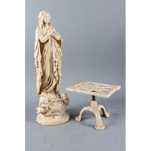 215 - An early 20th century enamelled cast iron adjustable trivet and a plaster figure of the Madonna