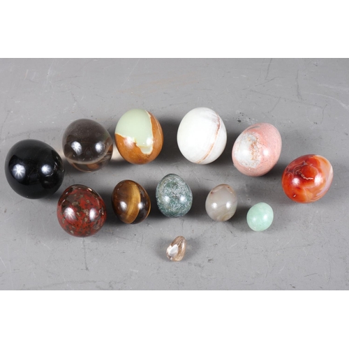 225 - A collection of turned hardstone eggs, various sizes, including jade, agate, Jasper, etc