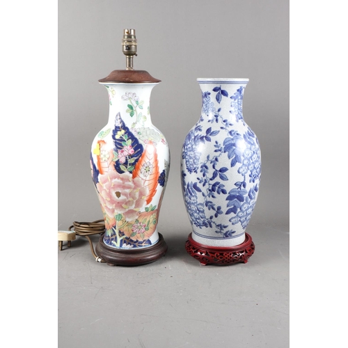 230 - A Chinese baluster vase with landscape decoration (now converted to a table lamp), on turned hardwoo... 