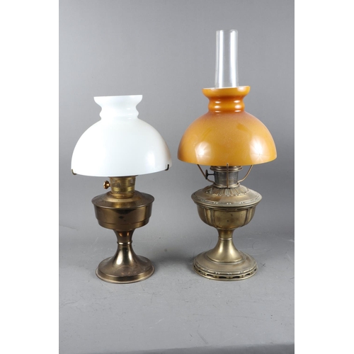 240 - Two brass oil lamps, on circular bases, tallest 23” high including chimney