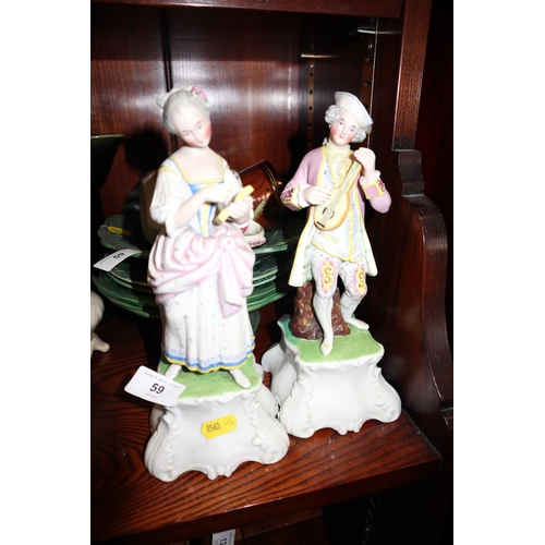 59 - A pair of Continental porcelain figures, a number of green glazed stoneware plates, and other decora... 