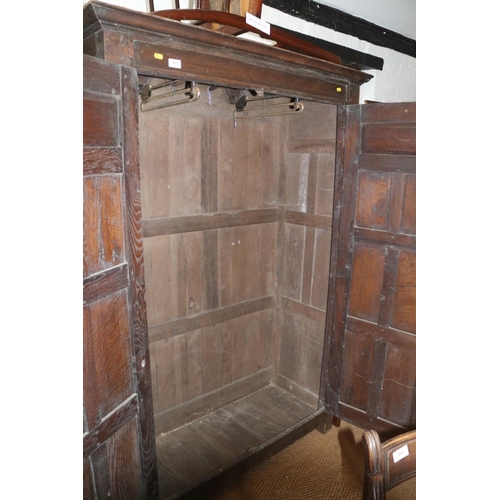 405 - An early 18th century panelled oak wardrobe enclosed two doors with cock head hinges, 45” wide... 