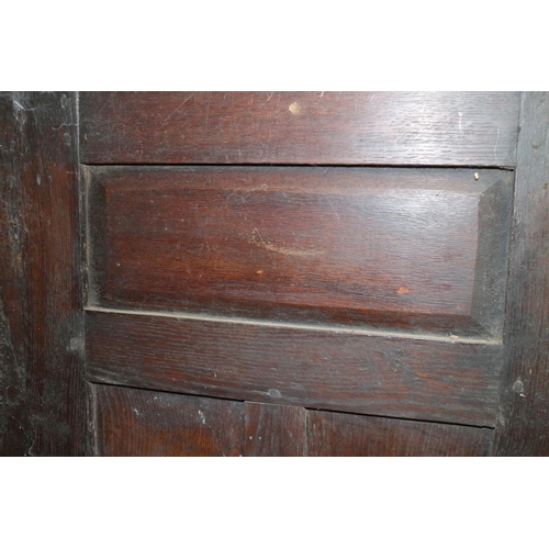 405 - An early 18th century panelled oak wardrobe enclosed two doors with cock head hinges, 45” wide... 