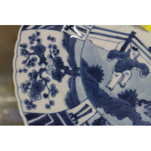 90 - A Chinese blue and white plate with figures in a landscape decoration and panelled borders Cracked a... 