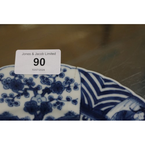 90 - A Chinese blue and white plate with figures in a landscape decoration and panelled borders Cracked a... 