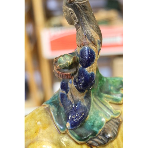 92 - A Chinese porcelain incense stand, modelled as Kuan Yin on a camel, on rockwork base, 12 1/4