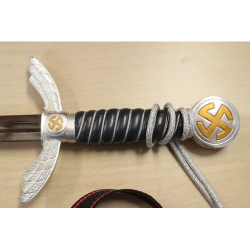 161 - A Luftwaffe officer's reproduction sword and scabbard, and a reproduction Goring Panzer dagger and s... 