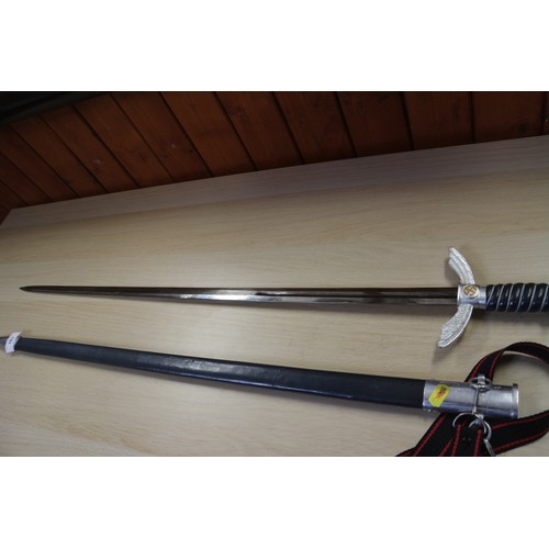 161 - A Luftwaffe officer's reproduction sword and scabbard, and a reproduction Goring Panzer dagger and s... 