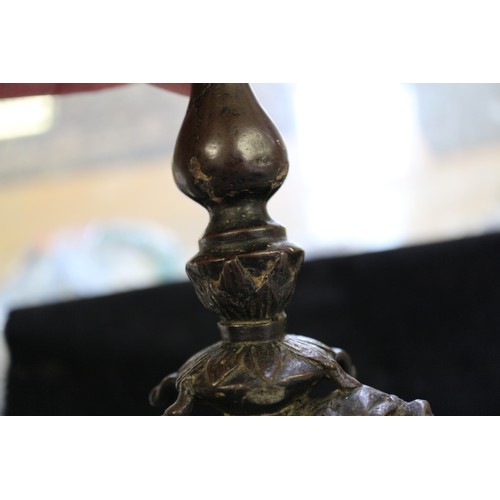 95 - A Chinese bronze pricket candlestick with dragon and lotus leaf design, 11 3/4” high