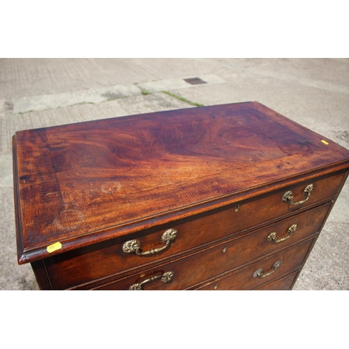 442 - An early Georgian Cuban mahogany chest of four long graduated drawers with gilt brass handles (one m... 