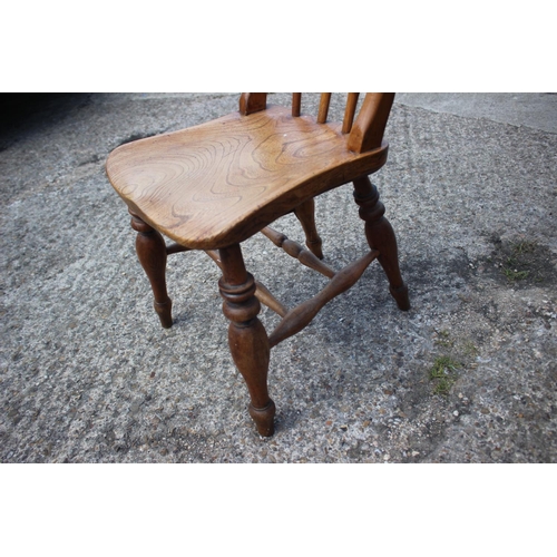 443 - A 19th century fruitwood Windsor spindle back chair with elm panel seat, on turned and stretchered s... 