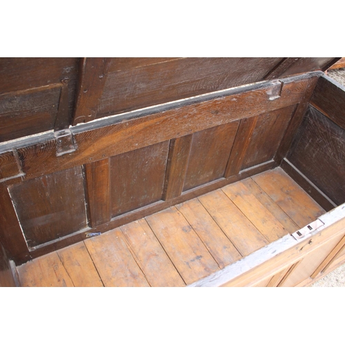 445 - A 18th century four panel front coffer with plank top, on moulded stile supports, 60