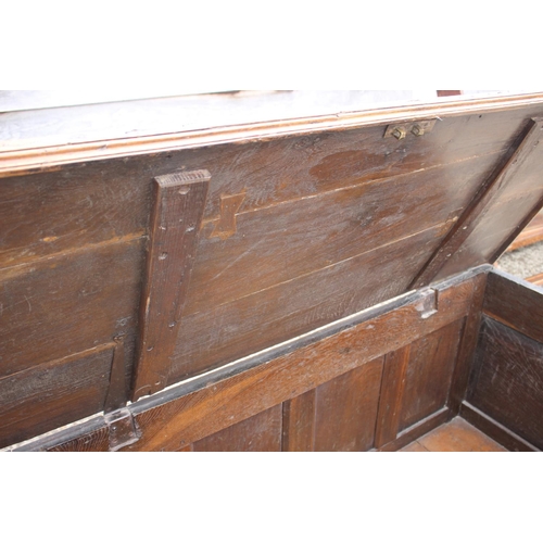 445 - A 18th century four panel front coffer with plank top, on moulded stile supports, 60