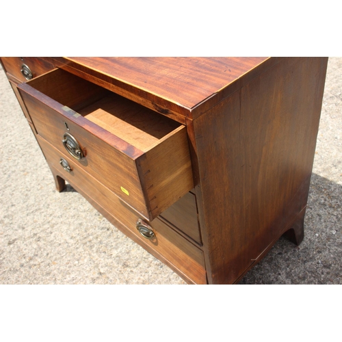 451 - An early 19th century mahogany chest of two short and two long drawers with stamped brass handles, o... 