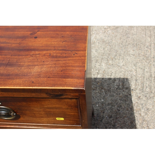 451 - An early 19th century mahogany chest of two short and two long drawers with stamped brass handles, o... 