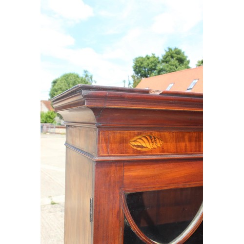 455 - A late Georgian mahogany and inlaid bookcase, the upper section enclosed Gothic lattice glazed doors... 