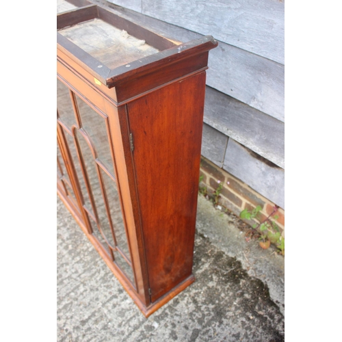 457 - A Victorian mahogany bookcase, the upper section enclosed glazed panelled doors over cupboards, 38” ... 