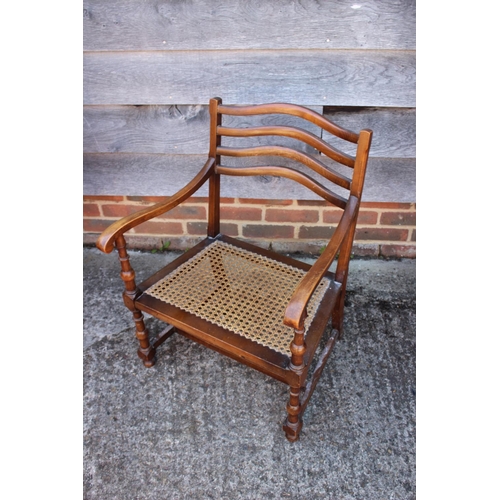 518 - An oak two-tier tea table and a cane seat low occasional chair