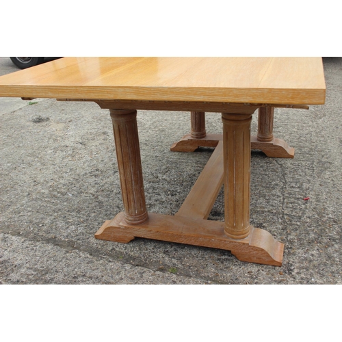 552 - A carved oak framed refectory dining table, on four fluted columns and splay support, 74