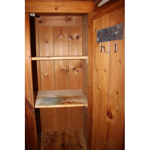 622 - A pine wardrobe enclosed two doors over two drawers with knob handles, on block base, 37