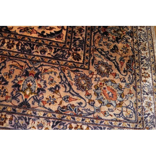 639 - A Kashan silk rug with central medallion and all-over foliate scroll design on a light ground and mu... 