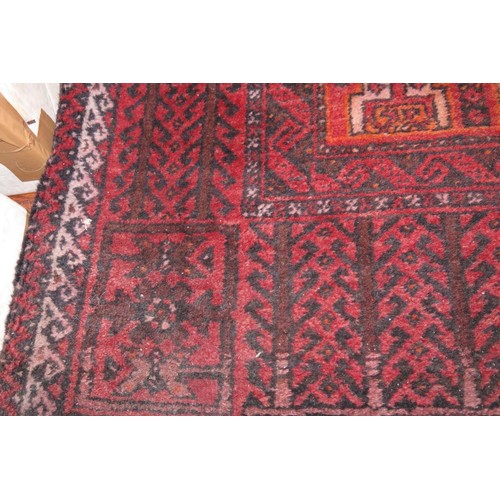 638 - A Caucasian tribal rug with geometric design and borders in shades of red, blue, cream and orange, 8... 