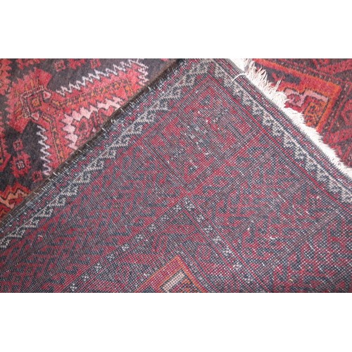 638 - A Caucasian tribal rug with geometric design and borders in shades of red, blue, cream and orange, 8... 