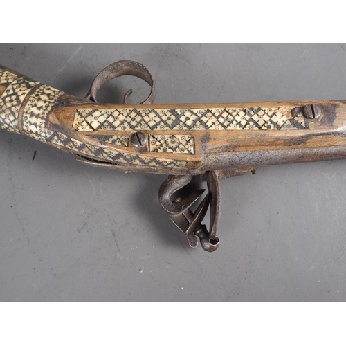 114 - An Afghan bone inlaid flint lock short musket, barrel 13