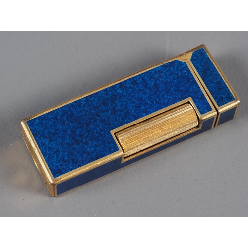 192 - A Dunhill dark blue and gilt metal lighter, a red leather Dunhill wallet and a black and gilt metal ... 