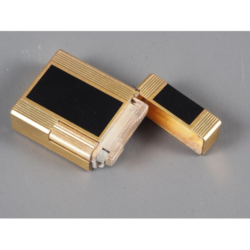 192 - A Dunhill dark blue and gilt metal lighter, a red leather Dunhill wallet and a black and gilt metal ... 