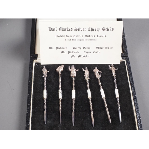 284 - A set of six silver cocktail sticks, modelled after Charles Dickens Characters, in fitted box, a sil... 