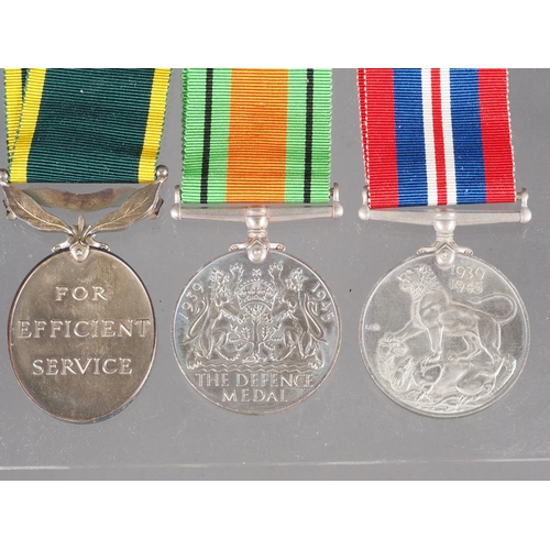 303 - A WWII British Territorial Efficiency Medal, engraved 7595650 S/SGT R.S Tonge R.A.O.C, a WWII Defenc... 